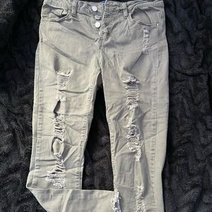 Light army green ripped jeans with split ends